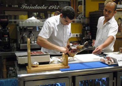 On our tapas tours, cutting acorn-fed Iberian ham in a tapas bar