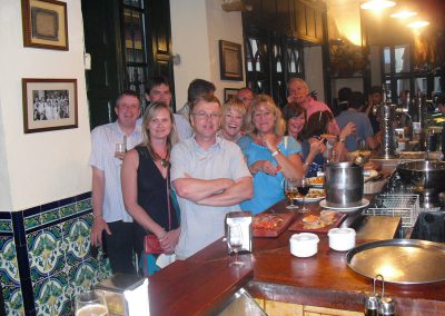 On our tapas tours, a group of people standing up in a a tapas bar