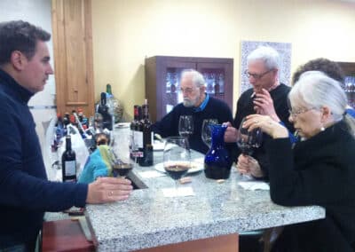 A group of people tasting wine at a winery