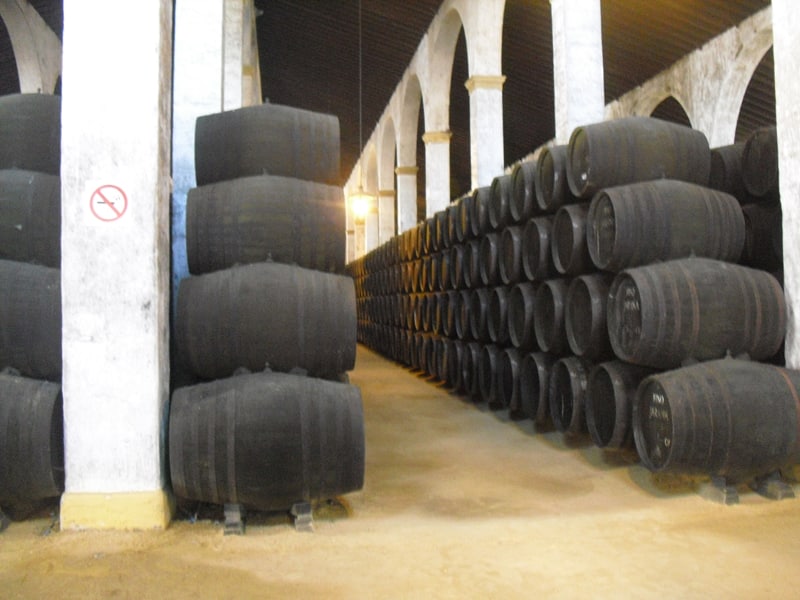 Stacks of sherry casks in side a winery building in Jerez